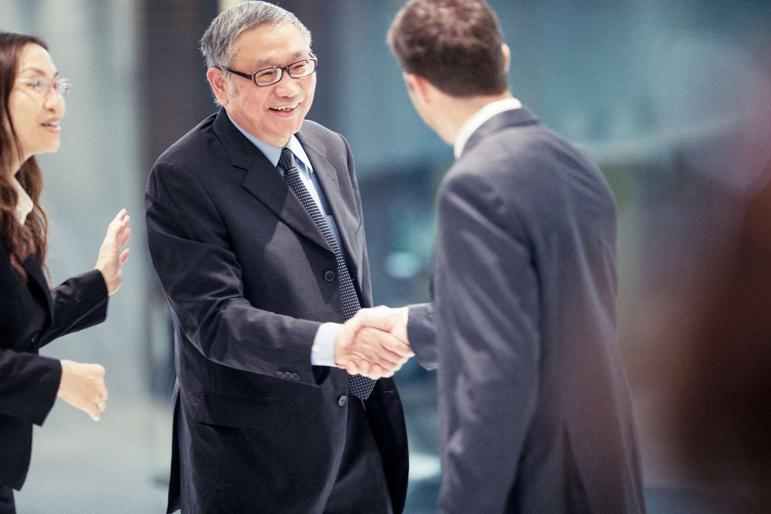 caucasian-businessman-closing-a-deal-in-hong-kong-with-his-asian-colleagues-942969420-5c7c646646e0fb000140a46b